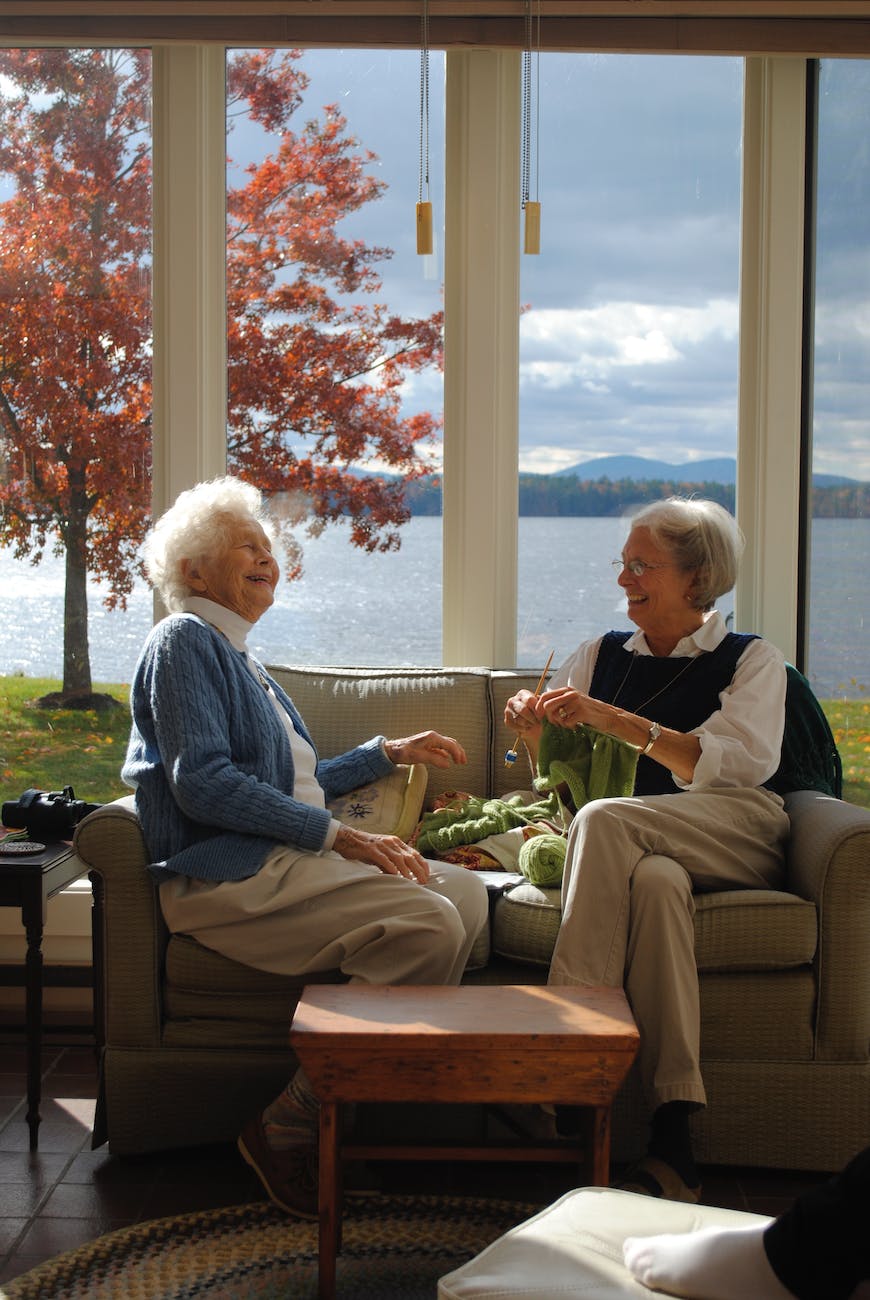 elderly woman sitting on sofa while having a conversation
